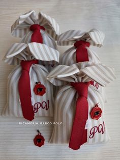 three small bags with ties on them sitting on a table