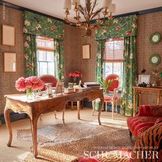 a living room filled with lots of furniture and flowers on top of a wooden table