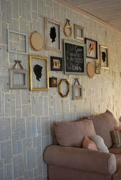 a living room filled with furniture and pictures on the wall