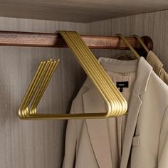 a coat and jacket hanger in a closet