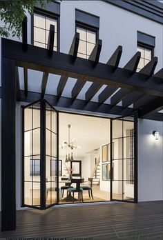 an outdoor dining area with glass doors and wooden flooring