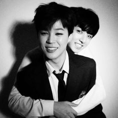 black and white photograph of two young men smiling at the camera with their arms around each other