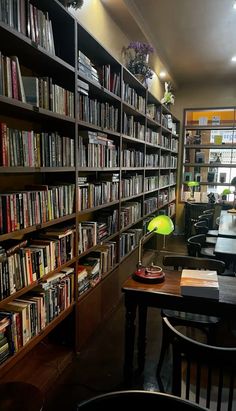 a library with tables, chairs and bookshelves full of books