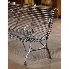 a metal bench sitting on top of a tiled floor