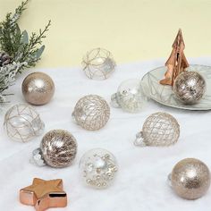 silver and gold ornaments on a white table cloth