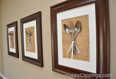 three framed pictures with forks and spoons attached to the side of a wall in a kitchen