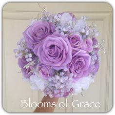 a bridal bouquet with purple roses and baby's breath