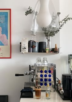 a coffee machine sitting on top of a white counter