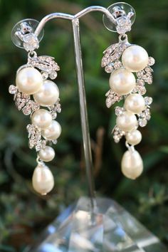 "Simply Chic.These earrings will sure make a big statment on your wedding day. Trinkling pearls surrounded with crystal petals and finished with a pear shape swarovski pearls .They are about 2 1/2 \" long. Matching bracelet available at this link https://www.etsy.com/listing/270957298/petals-and-leaves-rhinestone-crystal?ref=shop_home_active_1" Boho Wedding Jewelry Bohemian Bride, Wedding Cuff Bracelet, Wedding Jewelry Necklace, Simple Bridal Jewelry, Boho Bridal Jewelry, Boho Wedding Jewelry, Boho Wedding Earrings, Wedding Earrings Chandelier, Statement Earrings Wedding