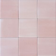 a pink tile wall with several different colors