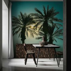 a dining room with palm trees painted on the wall and chairs in front of it