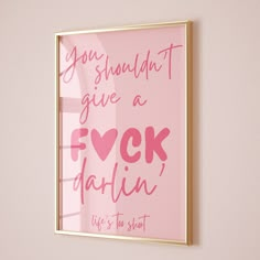 a pink poster hanging on the wall next to a window