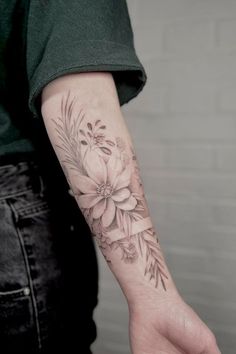 a person with a flower tattoo on their arm