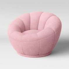 a pink chair sitting on top of a white floor