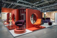 an exhibit with chairs and mirrors on display