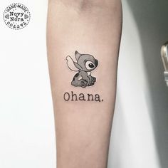 a small tattoo with the word ohana on it's left arm and an owl