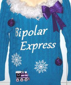 a blue sweater that says bipllar express with snowflakes and a train on it