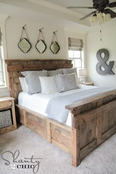 a bedroom with a bed, dresser and ceiling fan