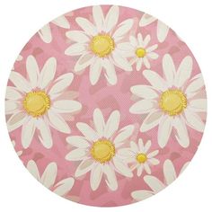 a pink and white flowered background with yellow centers on a circular surface, in the center is an image of daisies