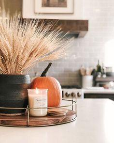 a candle is sitting on a tray in the kitchen