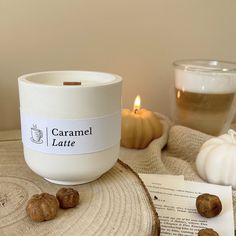 a candle that is sitting on top of a table next to some books and nuts