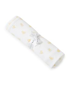 a baby's swaddle wrapped in white with yellow ducks and stars on it