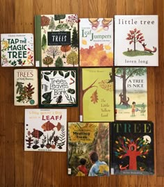 there are many children's books on the table together, including trees and leaves