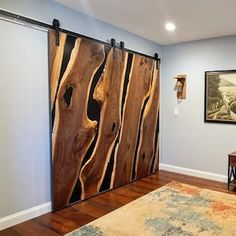 the sliding door is made out of wood and has metal hardware on it, along with an area rug