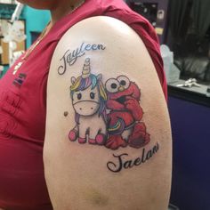 a woman with a tattoo on her arm has an image of a unicorn and crab