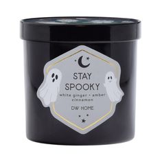 a black candle that says stay spooky while ghost is on the front and side