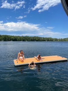 two women and a child are floating on a raft in the water