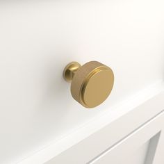 a close up of a knob on a white cabinet