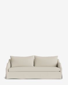 a white couch with two pillows on it