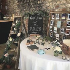 the table is set up for an event with pictures on it and flowers in vases