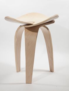 a wooden stool with curved legs on a white background