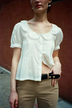 Sandy Liang Marl Top in Milky White - Short sleeved blouse in a lightweight White Cotton Voile - Scalloped collar detail with puffed sleeves - Mother of pearl buttons - Fits true to size - Fabric: 100% Cotton - XS: Length 21.5, Chest 38, Waist 38 - S: Length 22, Chest 40, Waist 40 - M: Length 22.5, Chest 42, Waist 42 Short Sleeved Blouse, Scalloped Collar, Sandy Liang, Milky White, 가을 패션, Puffed Sleeves, Cotton Voile, Pearl Buttons