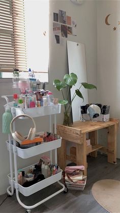 a room filled with lots of clutter next to a mirror and table in front of a window