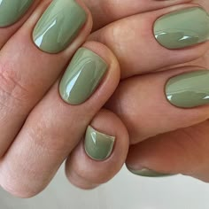 a woman's hand with green nail polish on her nails and manicures