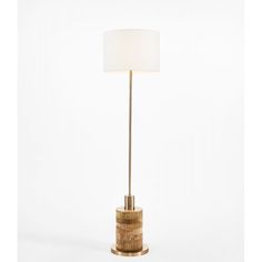 a gold table lamp with a white shade on the base and a round light fixture