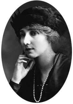 an old black and white photo of a woman with a feathered hat on her head