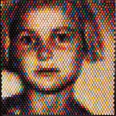 an image of a woman made out of many different colored dots on the side of her face