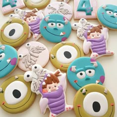 decorated cookies are arranged in the shape of monsters