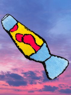 an image of a colorful kite flying in the sky at sunset or dawn with clouds