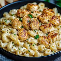 a bowl filled with macaroni and cheese on top of a table