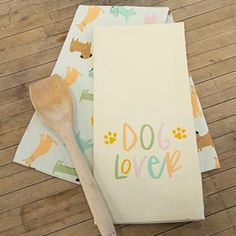 three napkins with dogs on them and a wooden spoon