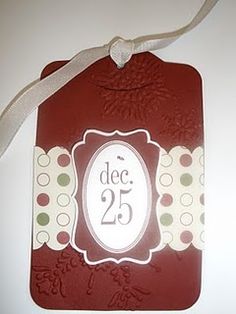 a tag with the number 25 on it is hanging from a white ribbon and has polka dots