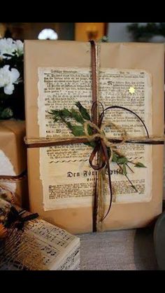 an old book wrapped in twine and tied up with a bow, sitting on a table