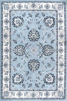 a blue and white rug with an ornate design on the center, surrounded by flowers