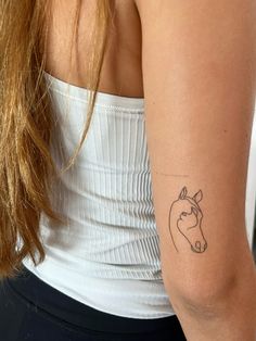 a woman's arm with a tattoo on her left arm and a cow drawn on it