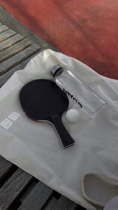 a ping pong paddle sitting on top of a white bag